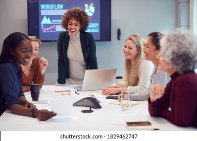 Pregnant  Businesswoman Leads Creative Meeting Of Women Collaborating Around Table In Modern Office