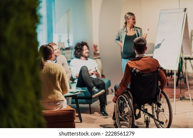  A pregnant businesswoman leads a creative meeting of a diverse business team in a modern coworking - Powered by Shutterstock