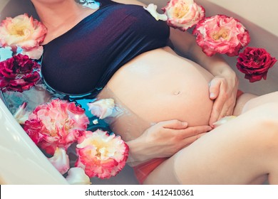 Pregnant Caucasian Woman Taking Relax Bath With Rose Flowers. Upper View.