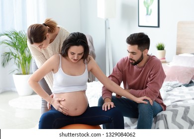 Pregnant couple with doula at home