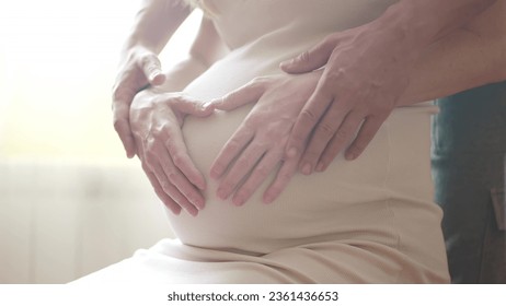 Pregnant couple husband and wife. family pregnancy expecting baby concept. man taking care of pregnant mother. baby in belly of pregnant woman husband hugs belly guards takes lifestyle care - Powered by Shutterstock