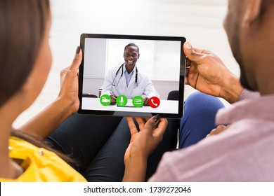 Pregnant Couple In Online Video Conference Call With Doctor