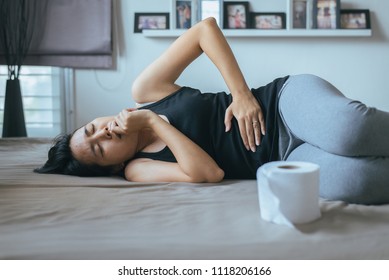 Pregnant Female Nausea In Bedroom,Asian Woman With Morning Sickness,Indigestible,Pelvic Pain,leucorrhoea