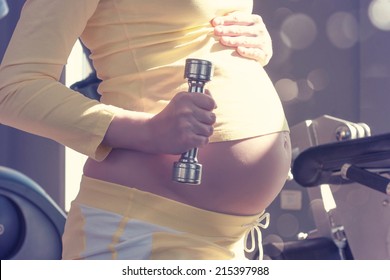 Pregnant Fitness Woman With Dumbbells