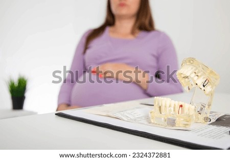 Pregnant girl in the dentist's office. The concept of treatment of caries and pulpitis during pregnancy. Elimination of foci of infection in the mouth. Inflammation of the gums, gingivitis. Copy space