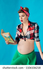Pregnant girl on blue background in pin-up style with book