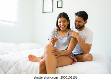 I'm pregnant! Goregous happy woman in her 20s feeling excited because of her positive pregnancy test and celebrating with her boyfriend