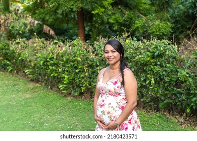 Pregnant Latina Woman With Dress Holding Her Belly