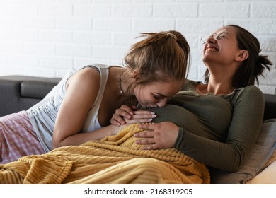 Pregnant  lesbian couple is excited about the arrival of their child.She was kissing her partner's belly.