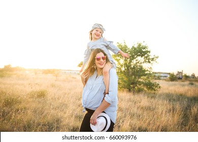 Pregnant Mother And Daughter Wear Matching Jean Clothes And Enjoy The Summer