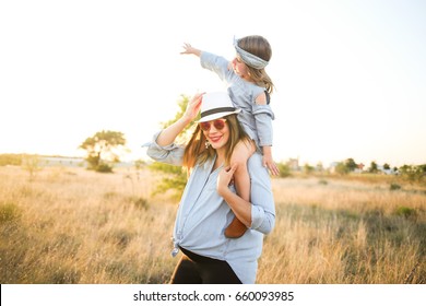 Pregnant Mother And Daughter Wear Matching Jean Clothes And Enjoy The Summer