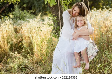 Pregnant mother with her daughter hug - Powered by Shutterstock