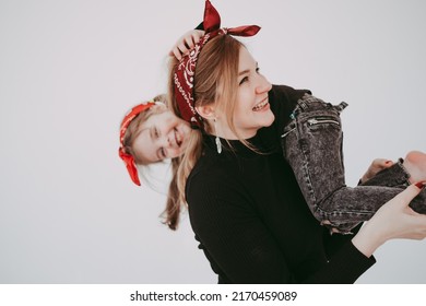 Pregnant Mother With Her Preschool Daughter Having Fun In Matching Outfits 