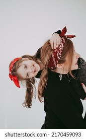 Pregnant Mother With Her Preschool Daughter Having Fun In Matching Outfits 