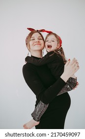 Pregnant Mother With Her Preschool Daughter Having Fun In Matching Outfits 