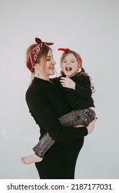 Pregnant Mother With Her Preschool Daughter Having Fun In Matching Outfits . High Quality Photo