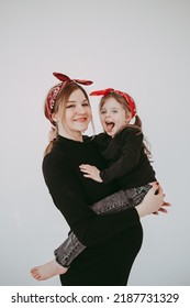 Pregnant Mother With Her Preschool Daughter Having Fun In Matching Outfits . High Quality Photo