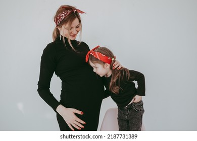 Pregnant Mother With Her Preschool Daughter Having Fun In Matching Outfits . High Quality Photo