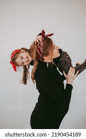 Pregnant Mother With Her Preschool Daughter Having Fun In Matching Outfits 