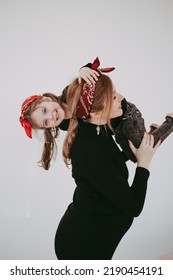 Pregnant Mother With Her Preschool Daughter Having Fun In Matching Outfits 