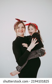 Pregnant Mother With Her Preschool Daughter Having Fun In Matching Outfits 