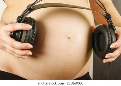 Pregnant Mother Playing Lullaby With Headphones