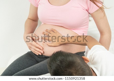 Pregnant mother with son Talk and tease Hands on the stomach