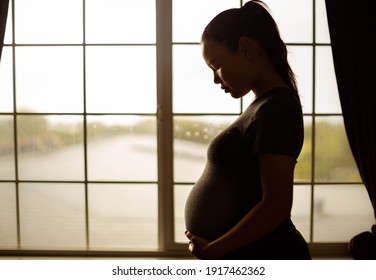 A Pregnant Mother Thinking About Her Baby, Tired Alone At Home. Depression And Stress.