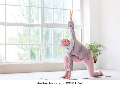 Pregnant Muslim Woman Doing Yoga At Home