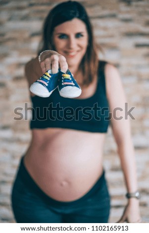 Similar – Image, Stock Photo Baby sneakers held by pregnant