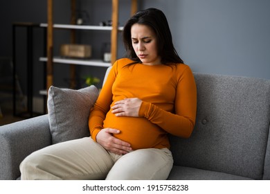 Pregnant Sick Woman With Headache, Discomfort And Pain