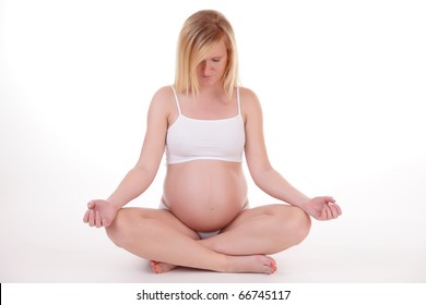 pregnant teen is doing meditaion. yoga is good for health of the unborn baby