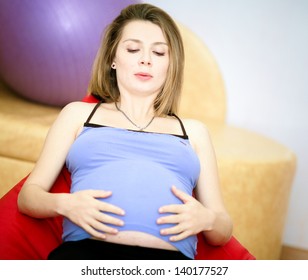 Pregnant woman in armchair in delivery room