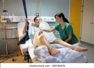 Pregnant Woman Assisted By A Nurse In A Delivery Room