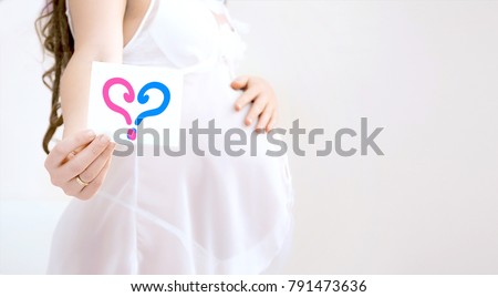 Pregnant woman belly holding  ultrasound scan of baby. Healthy pregnancy. Newborn baby booties in parents hands. Concept of Pregnancy health care. Boy or girl.