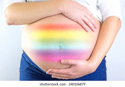 Pregnant woman belly with rainbow symbol LGBT 