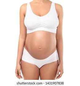 Pregnant woman with big belly wearing lingerie on white background