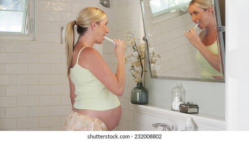 Pregnant Woman Brushing Her Teeth