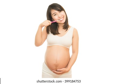 Pregnant Woman Brushing Her Teeth