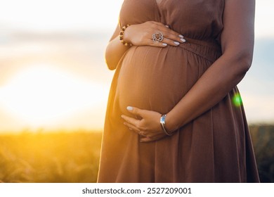 Pregnant Woman Caressing Belly On Wheat Natural Field Background. Belly baby bump in 2nd trimester. Expectant mother with tummy cares about health High quality - Powered by Shutterstock