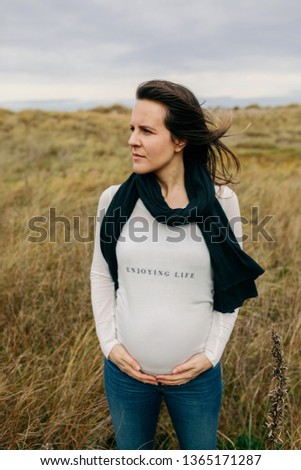 Similar – Unrecognizable pregnant woman showing ultrasound of her baby on the mobile