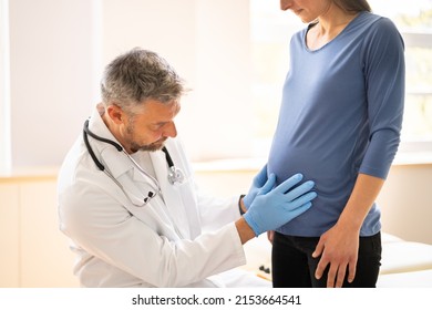 Pregnant Woman At Chiropractor. Baby Breech Physiotherapy And Pregnancy