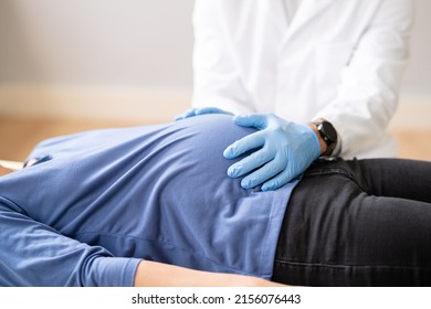 Pregnant Woman At Chiropractor. Baby Breech Physiotherapy And Pregnancy