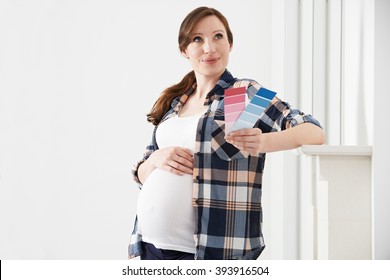 Pregnant Woman Choosing Color Scheme Fort Baby's Room - Powered by Shutterstock