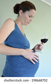 Pregnant Woman Craving To Drink Alcohol (red Wine) During Pregnancy. Concept Photo Of Pregnancy, Pregnant Woman Lifestyle And Health Care.Real People. Copy Space