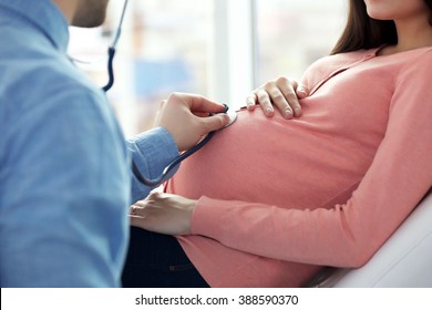 Pregnant Woman With Doctor At Hospital