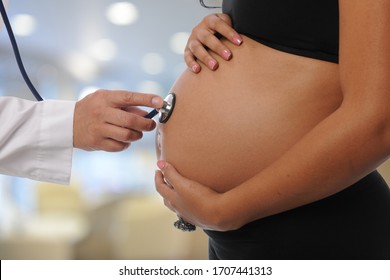 Pregnant woman at Doctor office being examined 