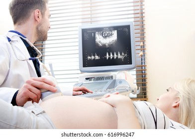 Pregnant Woman At The Doctor. Ultrasound Diagnostic Machine. Ultrasound Transducer Woman Pregnant Doctor Prenatal Care Clinic Concept