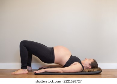 Pregnant Woman Doing Bridge Yoga Pose