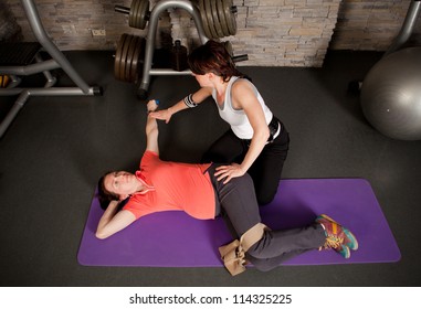 A pregnant woman doing exercises using fitness ball
